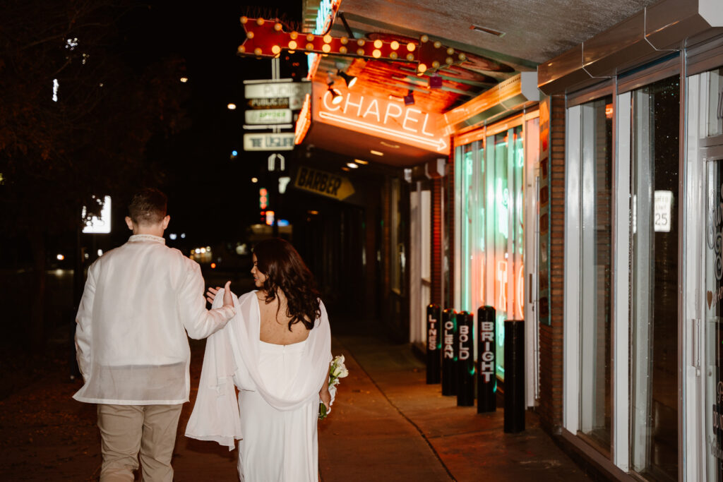 Just married couple walking outside Sure Thing Chapel in downtown Las Vegas after elopement ceremony